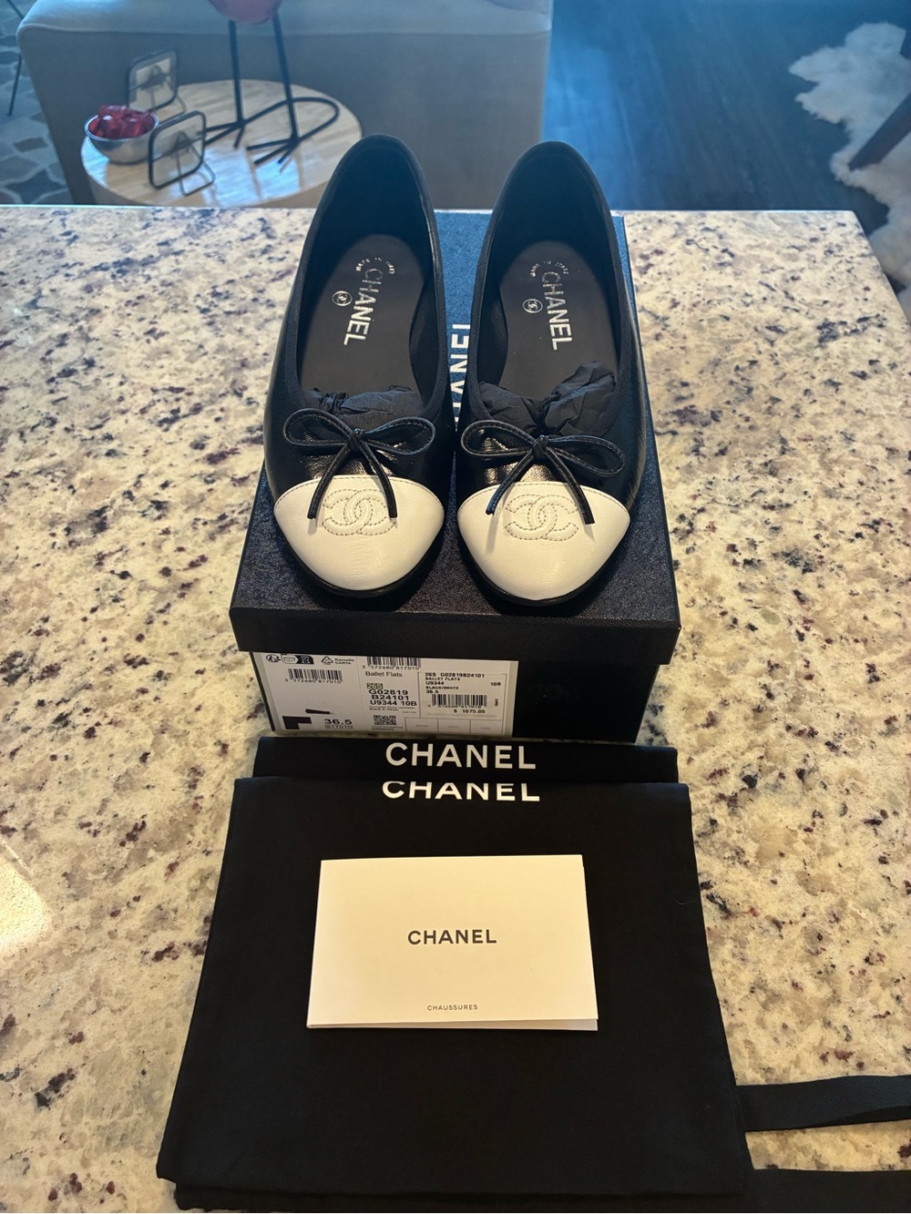 CHANEL Black Leather Ballet Flats with White Cap Toe and Bow